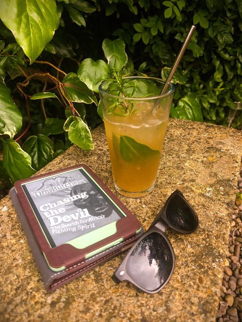 Photo of a Dark and Stormy Cocktail next to the book 'Chasing the Devil- Time Butcher 
